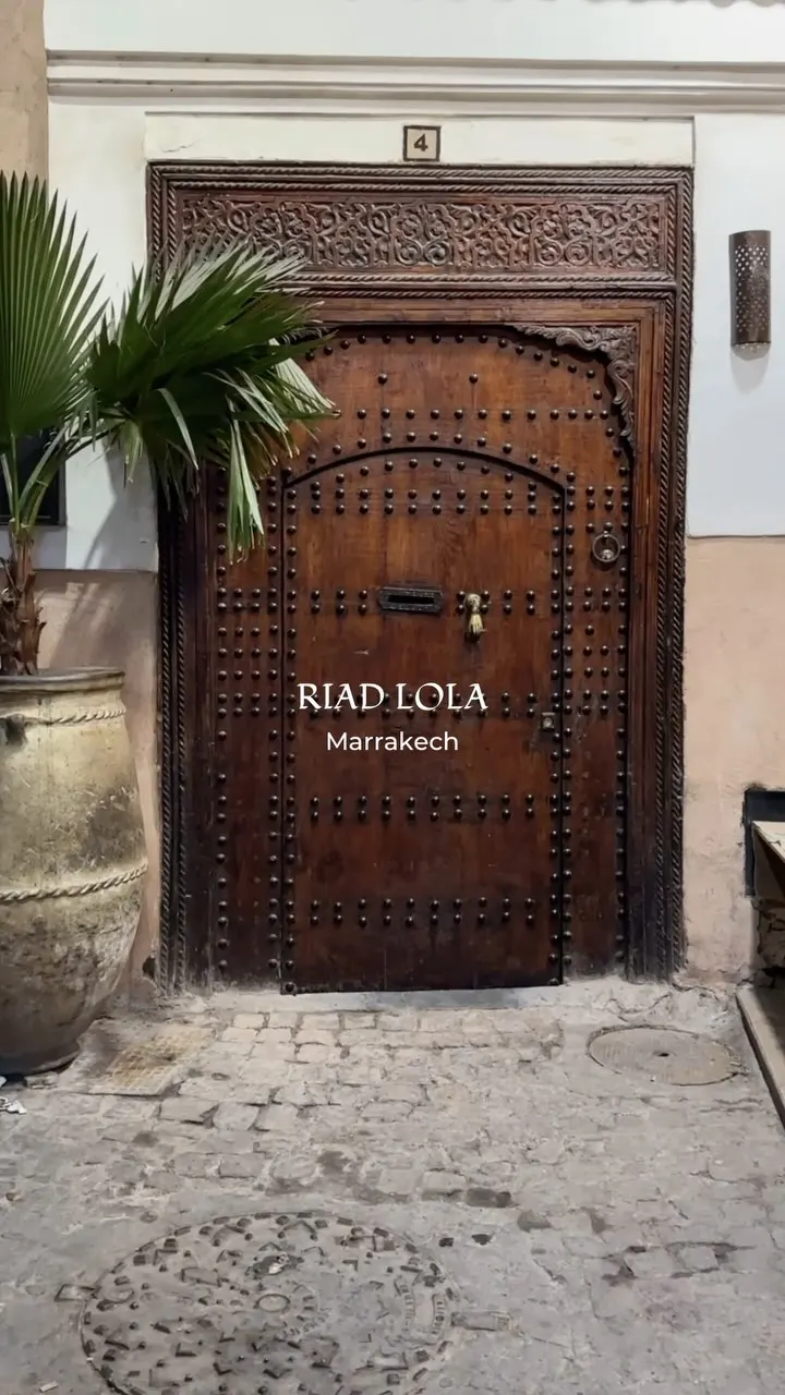 The carved wooden entrance sign of Riad Lola, Marrakech