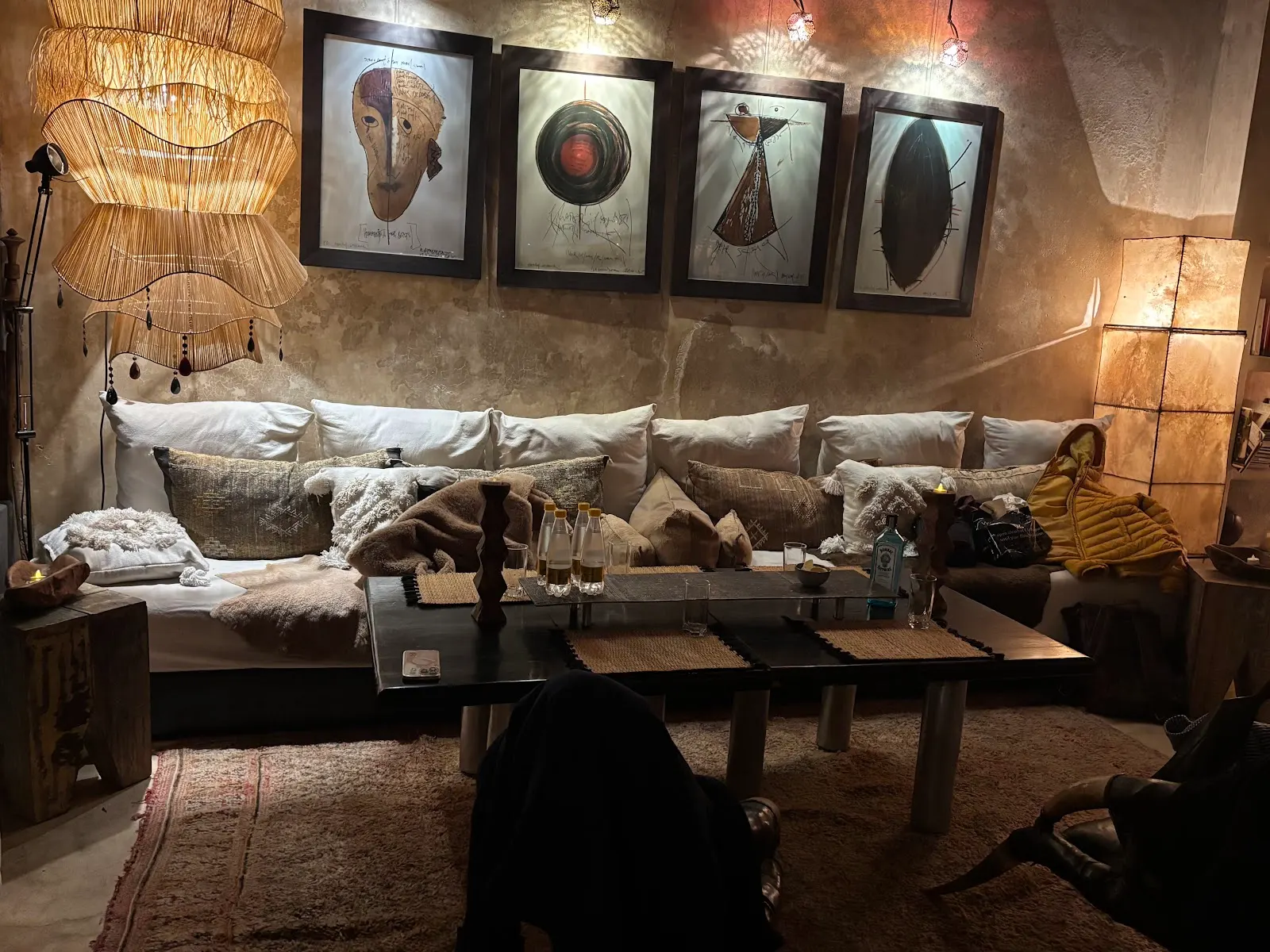 A gallery wall of framed prints above a linen sofa