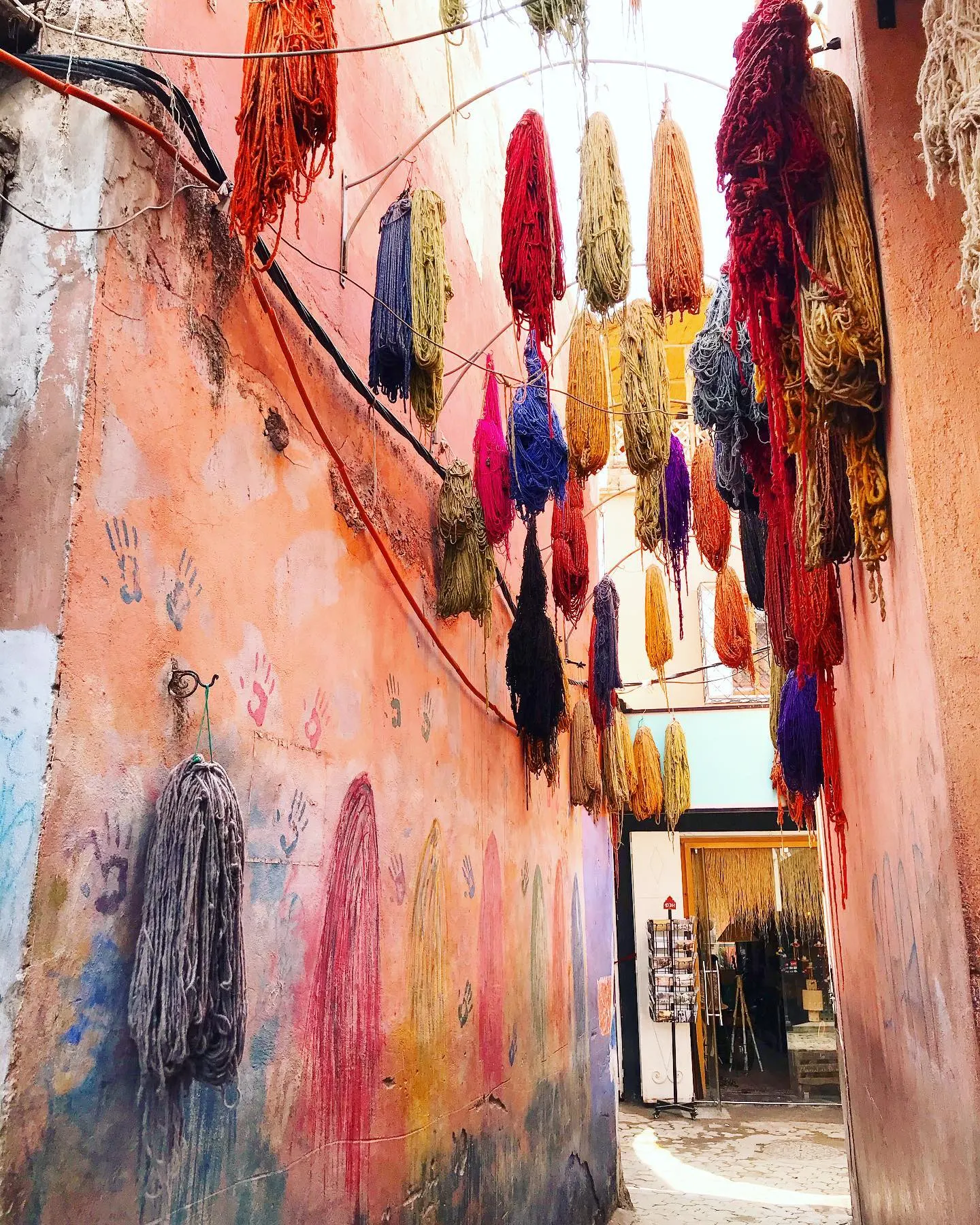 A medina alley hung with dyed wool in the souks