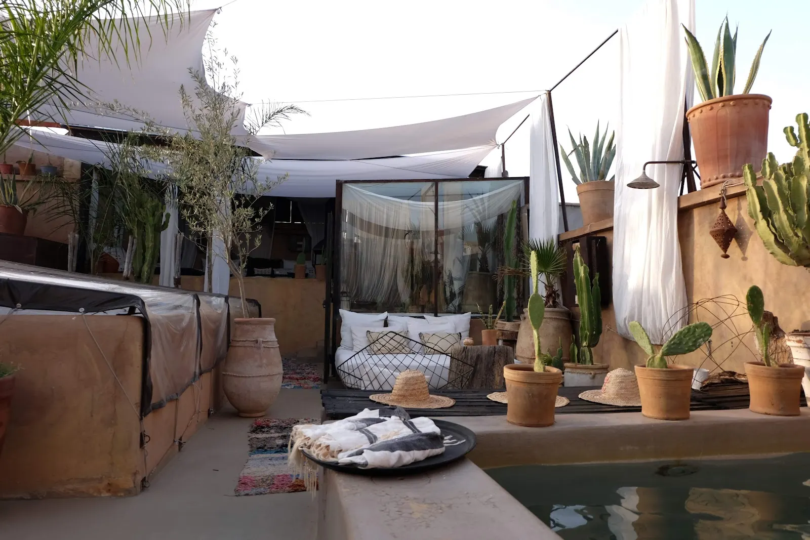 Rooftop daybeds under white canopies at Riad Lola