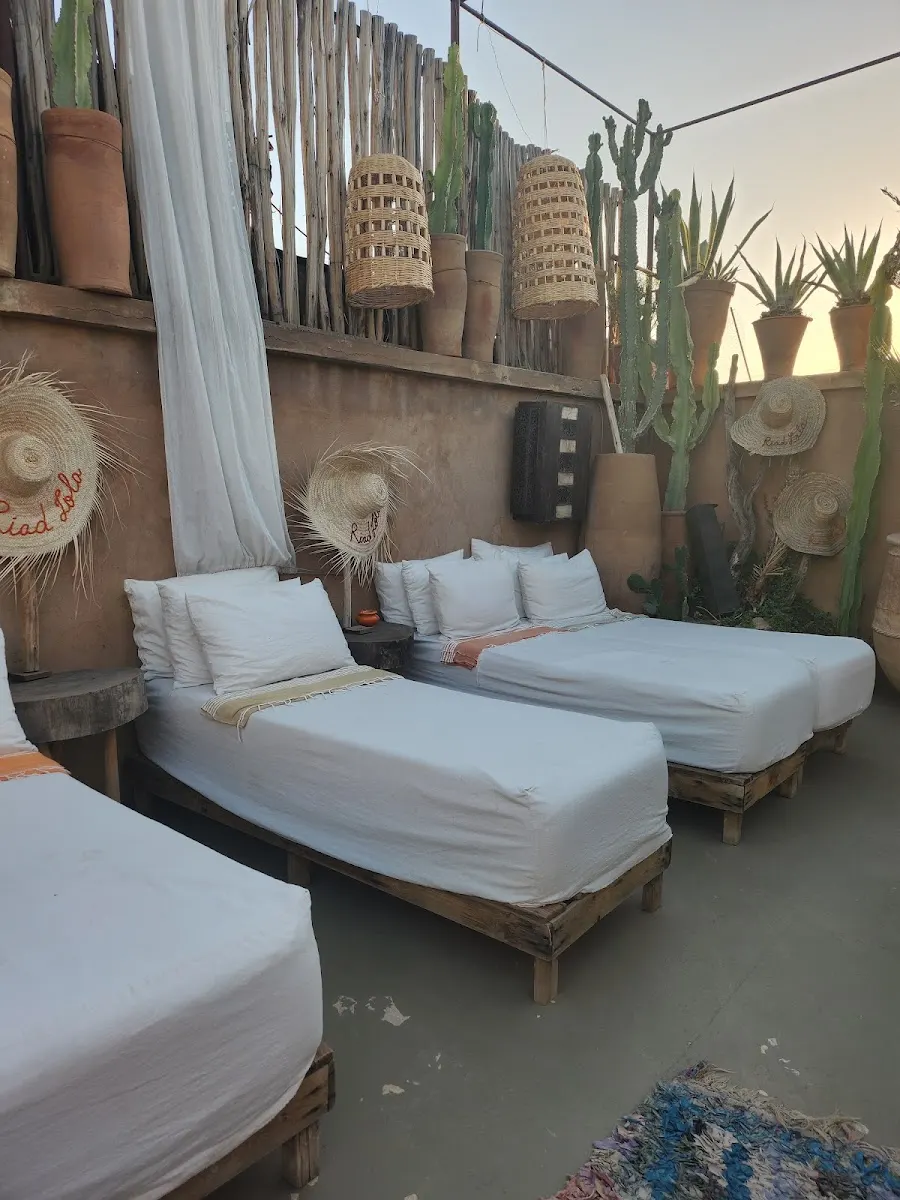 Twin beds in white linen with woven runners