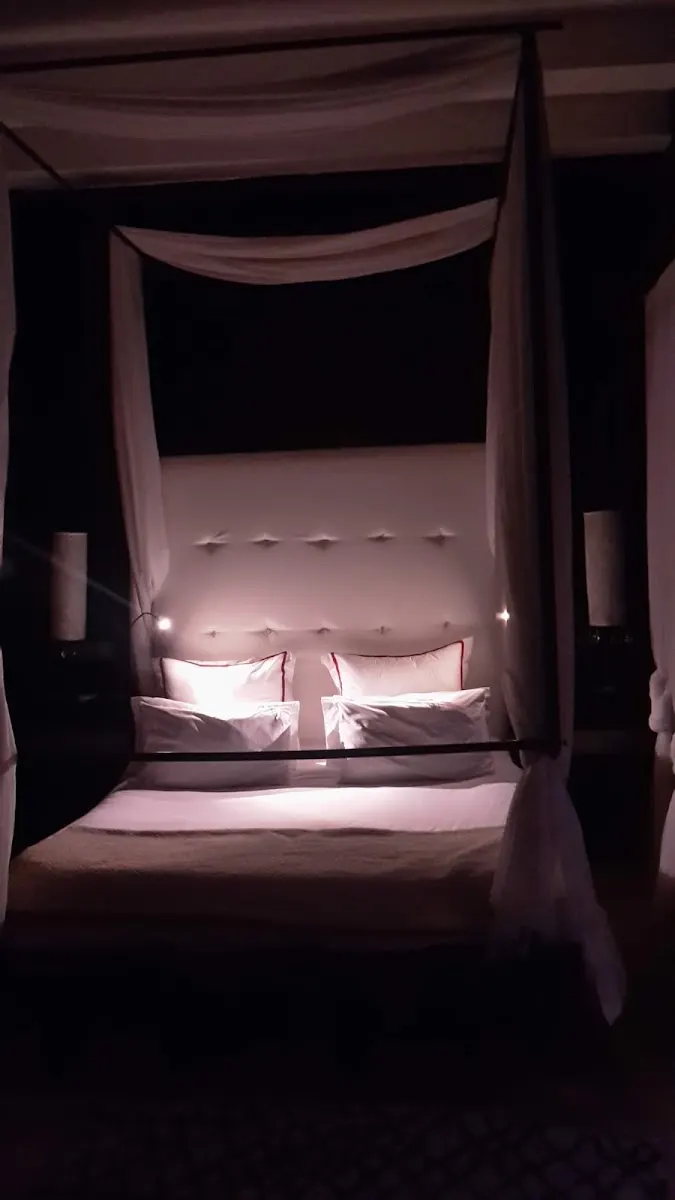 A canopy bed in soft evening light