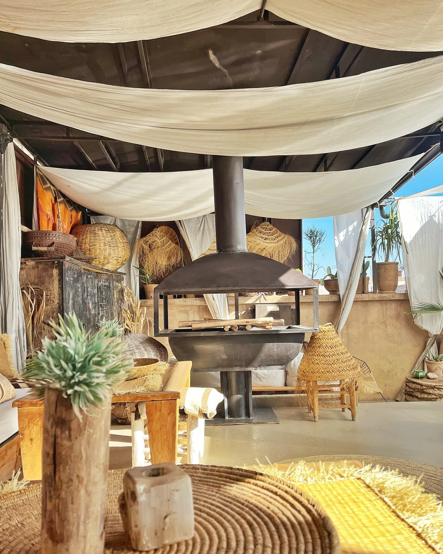 A white canopy lounge with Berber cushions
