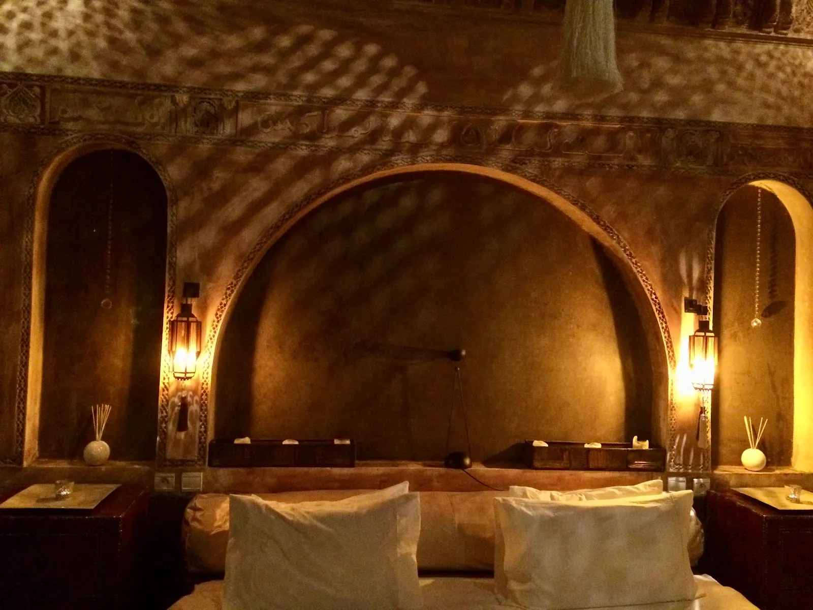 The arched fireplace salon at night, candles lit